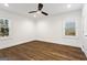 Bedroom with natural light from two windows, ceiling fan and hardwood floors at 4178 Castle Pines Ct, Tucker, GA 30084