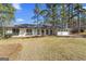 Charming ranch-style home featuring a brick exterior and lush, mature trees in a well-maintained front yard at 4178 Castle Pines Ct, Tucker, GA 30084