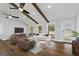 Inviting living room with hardwood floors, vaulted ceilings, wood beams, and ample natural light at 4178 Castle Pines Ct, Tucker, GA 30084