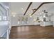 Open-concept living space with hardwood floors, dining area, and a glimpse of the modern kitchen at 4178 Castle Pines Ct, Tucker, GA 30084