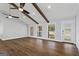 Living room with hardwood floors, ceiling fans and wood beams on the ceiling at 4178 Castle Pines Ct, Tucker, GA 30084