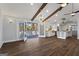 Bright living room featuring access to the outdoor deck, hardwood floors, and a modern kitchen at 4178 Castle Pines Ct, Tucker, GA 30084