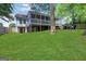 Lush backyard showcasing a well-maintained lawn, a patio area, and a glimpse of outdoor seating at 792 Mimosa Se Dr, Marietta, GA 30060