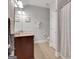 Bathroom featuring a double sink vanity, a mirror and a shower with patterned curtains at 792 Mimosa Se Dr, Marietta, GA 30060