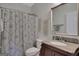 Bathroom with a tub-shower combo and an elegant single-sink vanity featuring a granite countertop at 792 Mimosa Se Dr, Marietta, GA 30060