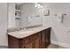 Bathroom vanity with double sinks, granite countertop, and decorative mirror showcasing shelves at 792 Mimosa Se Dr, Marietta, GA 30060