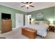 A spacious bedroom with green walls, a queen bed, and a ceiling fan for added comfort at 792 Mimosa Se Dr, Marietta, GA 30060