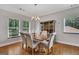 Bright dining room with natural light showcasing stylish chairs and a china cabinet at 792 Mimosa Se Dr, Marietta, GA 30060