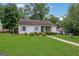Charming home with a well-manicured lawn, stone accents, and inviting curb appeal at 792 Mimosa Se Dr, Marietta, GA 30060