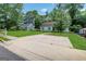 Charming single-story home with lush green lawn, mature trees, and a concrete driveway at 792 Mimosa Se Dr, Marietta, GA 30060