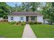 Charming single-story home with a lush lawn, stone accents, and inviting walkway at 792 Mimosa Se Dr, Marietta, GA 30060