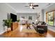 Cozy living room with hardwood floors, a ceiling fan, built-in shelving, and comfortable seating at 792 Mimosa Se Dr, Marietta, GA 30060