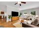 Spacious living room featuring hardwood floors, a ceiling fan, and large windows for natural light at 792 Mimosa Se Dr, Marietta, GA 30060