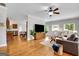 Bright living room featuring hardwood floors, a ceiling fan, and large windows for natural light at 792 Mimosa Se Dr, Marietta, GA 30060