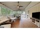Inviting screened porch with comfortable seating, dining area, and outdoor TV for relaxing at 792 Mimosa Se Dr, Marietta, GA 30060