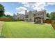 Fenced backyard featuring a covered structure with curtains and a well-maintained lawn at 412 Middlebrooke St, Canton, GA 30115