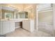 Bathroom featuring a double sink vanity with white cabinets, large mirrors, and tile floor at 412 Middlebrooke St, Canton, GA 30115