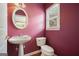 Charming half bath with a pedestal sink, toilet, and a decorative oval mirror at 412 Middlebrooke St, Canton, GA 30115