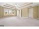 Spacious primary bedroom featuring gray carpeting, a trey ceiling, and large window for natural light at 412 Middlebrooke St, Canton, GA 30115
