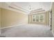 Spacious bedroom featuring gray carpeting, a trey ceiling, and large window for natural light at 412 Middlebrooke St, Canton, GA 30115