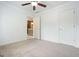 Carpeted bedroom featuring a ceiling fan and closet, offering ample space at 412 Middlebrooke St, Canton, GA 30115