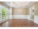 Dining room featuring hardwood floors, wainscoting, tray ceiling, and a chandelier at 412 Middlebrooke St, Canton, GA 30115