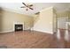 Cozy living room featuring a fireplace, wood floors, and staircase access to the upper level at 412 Middlebrooke St, Canton, GA 30115