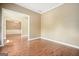 Open-concept living room with hardwood floors and neutral paint at 412 Middlebrooke St, Canton, GA 30115