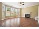 Bright living room with wood floors, a fireplace, and large windows overlooking the backyard at 412 Middlebrooke St, Canton, GA 30115