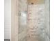Bathroom shower featuring marble tiles, glass door, rainfall shower head, and built in shelf at 412 Middlebrooke St, Canton, GA 30115