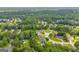 Wide aerial view of a residential neighborhood with mature trees and well-maintained homes in a suburban setting at 684 Doe Lane Ln, Loganville, GA 30052