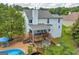 Aerial view of a house with a deck, swimming pool, manicured lawn and mature trees at 684 Doe Lane Ln, Loganville, GA 30052
