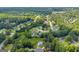 Aerial neighborhood view showing a community with tree-lined streets and diverse housing styles in Loganville, GA at 684 Doe Lane Ln, Loganville, GA 30052