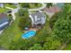 Aerial view of a backyard featuring a deck, patio furniture, an above ground swimming pool, and landscaped yard at 684 Doe Lane Ln, Loganville, GA 30052