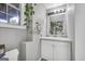Bathroom featuring a sink, a window, and climbing plants at 684 Doe Lane Ln, Loganville, GA 30052