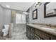 Modern bathroom featuring a glass-enclosed shower and dual sink vanity with granite countertop at 684 Doe Lane Ln, Loganville, GA 30052