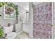 Bathroom features cherry blossom shower curtain and large window at 684 Doe Lane Ln, Loganville, GA 30052