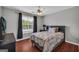 Comfortable bedroom with hard surface floors, a window view, and a serene atmosphere at 684 Doe Lane Ln, Loganville, GA 30052