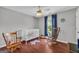 Cozy Bedroom with hardwood floors, rocking chairs, a crib, and charming decor at 684 Doe Lane Ln, Loganville, GA 30052
