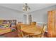 Warm dining room with hardwood floors, a wooden table, and a cozy bookshelf, creating a welcoming atmosphere at 684 Doe Lane Ln, Loganville, GA 30052
