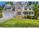 Charming two-story home with stone accents, manicured lawn, and attached two car garage at 684 Doe Lane Ln, Loganville, GA 30052
