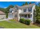 Well-maintained two-story home features stone accents, shutters and a beautiful lawn at 684 Doe Lane Ln, Loganville, GA 30052