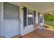 Covered front porch with seating and shade, perfect for enjoying the outdoors at 684 Doe Lane Ln, Loganville, GA 30052
