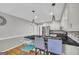 Bright kitchen features stainless steel appliances, gray cabinets, and granite countertops with seating for three at 684 Doe Lane Ln, Loganville, GA 30052