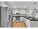 Modern kitchen with stainless steel appliances, sleek countertops, and white cabinets, perfect for cooking enthusiasts at 684 Doe Lane Ln, Loganville, GA 30052