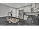 Kitchen showcasing stainless steel refrigerator, black granite countertops, and tile backsplash at 684 Doe Lane Ln, Loganville, GA 30052