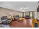 Spacious living room with a ceiling fan and multiple leather sofas and chair, creating a welcoming atmosphere at 684 Doe Lane Ln, Loganville, GA 30052