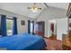Comfortable main bedroom with wood floors, vaulted ceilings, and ample natural light at 684 Doe Lane Ln, Loganville, GA 30052