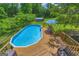Backyard with an above ground pool and wooden deck perfect for outdoor fun and relaxation at 684 Doe Lane Ln, Loganville, GA 30052