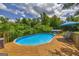 Backyard features a sparkling above ground pool and wooden deck surrounded by mature trees at 684 Doe Lane Ln, Loganville, GA 30052